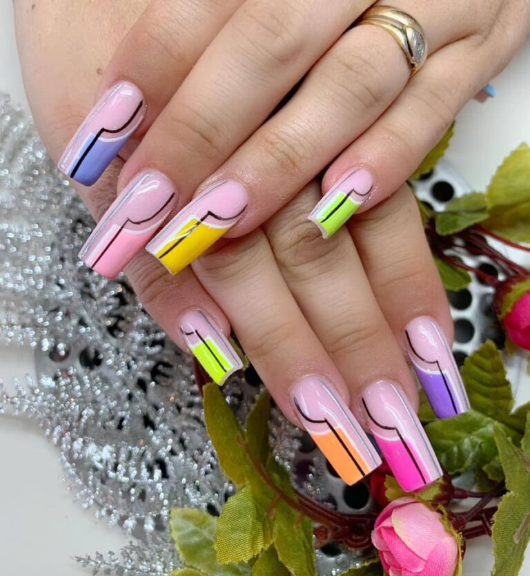 Colorful abstract nail art with pastel pink base and neon accents at The Grand Nails of America in Houston.