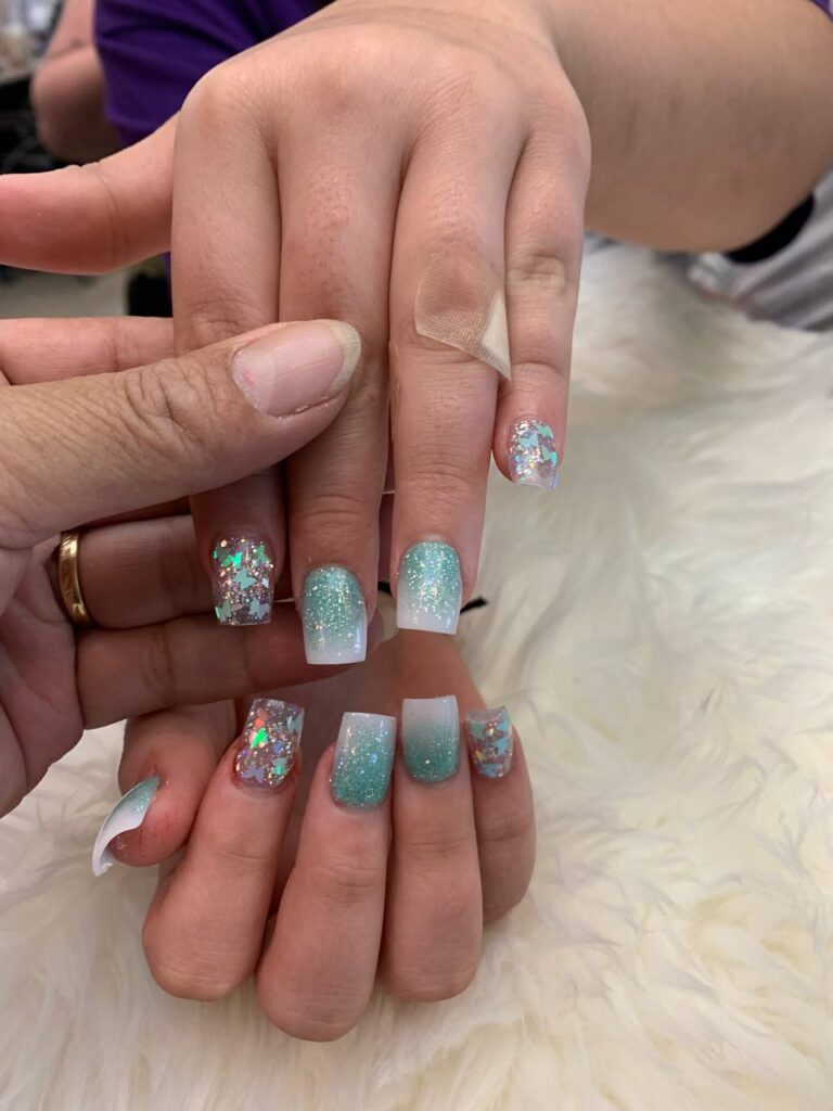 Soft pastel nail design with a sparkling glitter finish, showcasing the refined artistry at The Grand Nails of America in Houston