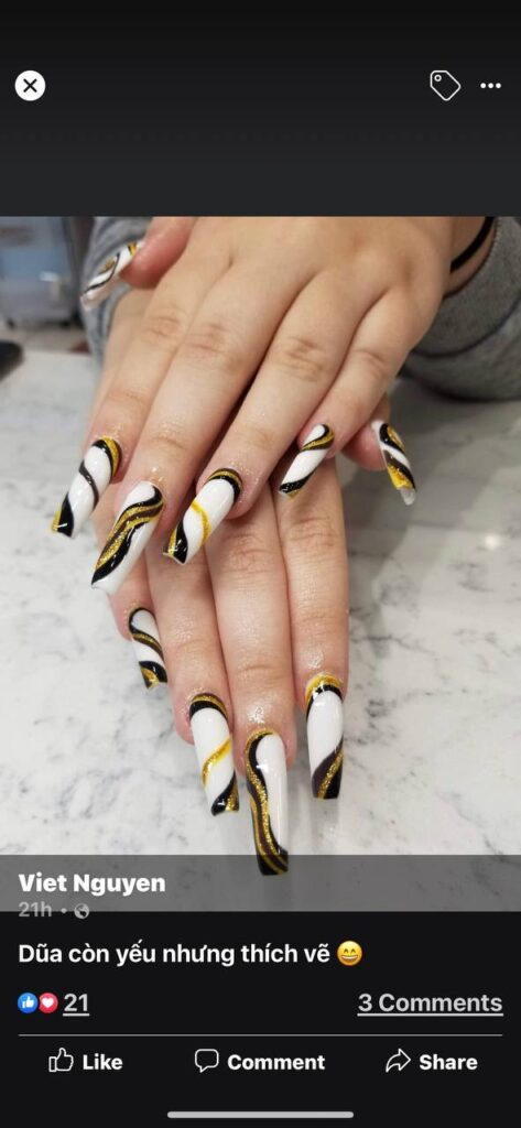 Elegant white and gold swirl nail art on stiletto nails, a signature style from The Grand Nails of America in Houston, Texas.